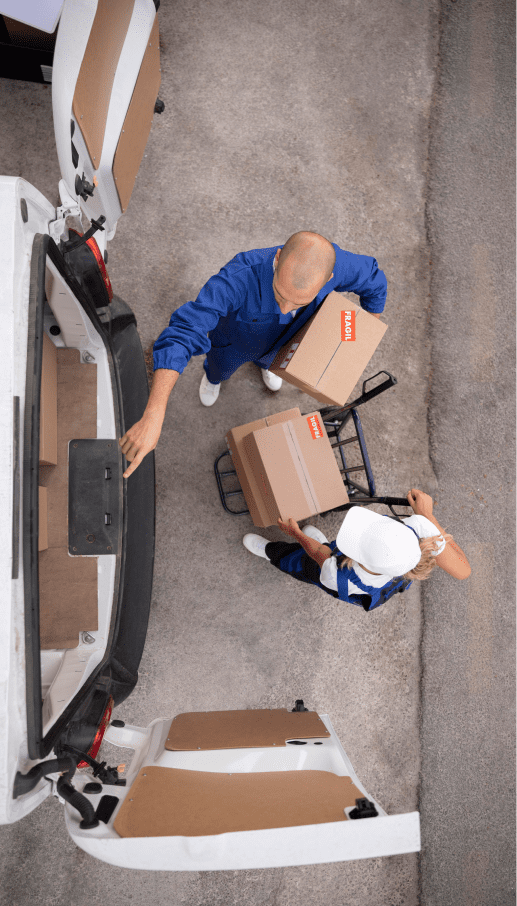 Commercial Insurance - Two warehouse employees looking into the backend of a van and loading boxes.