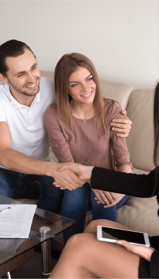 Couple shaking hands with a woman in a suit shows example of people who could use personal lines insurance