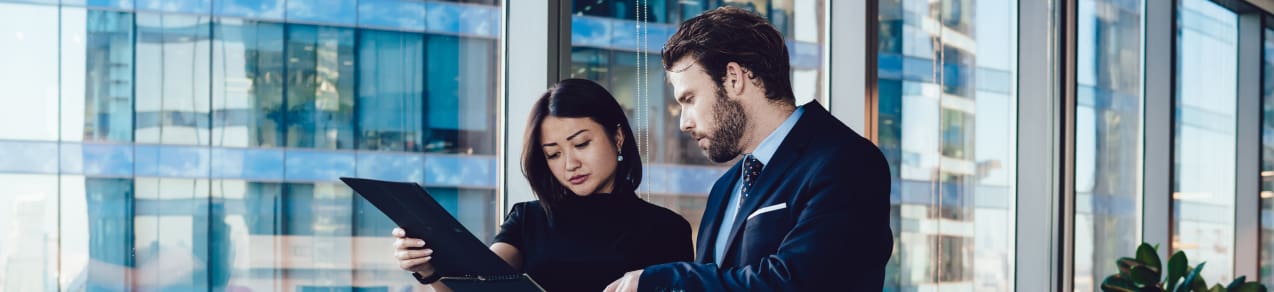 Leader reviewing information with a subordinate showing an example of a business function that might need directors and officers insurance