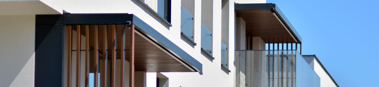 Large modern home exterior shown as an example of a home that would be best protected with umbrella policy insurance.